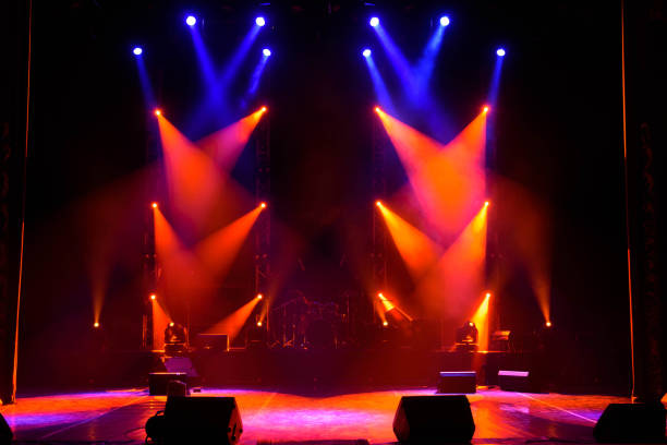 istock scene, stage light with colored spotlights and smoke 1308387770