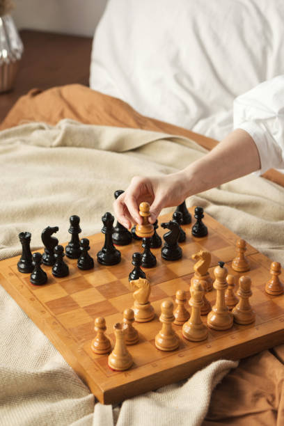 istock Chess Player Woman Hand. White Pawn Step Forward 1308388132