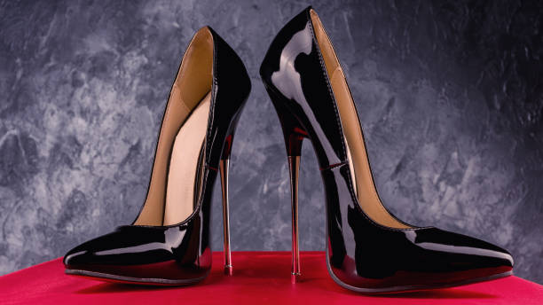 istock Black fetish shiny patent leather stiletto high heels with ankle strap 1308390197