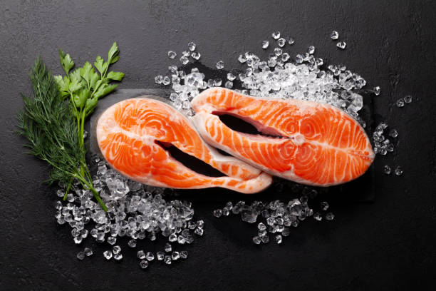 istock Fresh raw salmon cooking. Fish steaks with herbs and spices 1308391052