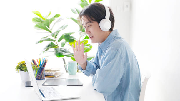 istock Video conference, Work from home, Asian man making video call to business team with virtual web, Contacting colleague by conference on laptop computer at home, Coworker talking on web, Online consultation business 1308391081