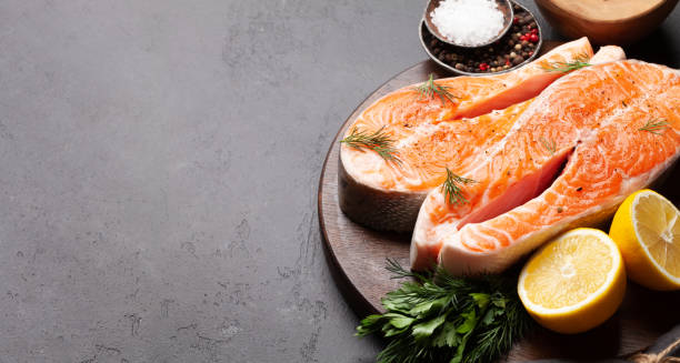 istock Fresh raw salmon cooking. Fish steaks with herbs and spices 1308391164
