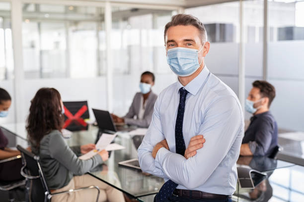 istock Happy businessman with face mask during covid 1308391205