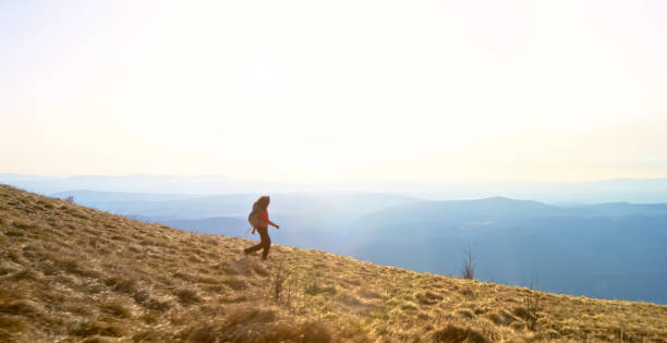 istock Mature woman walking on mountain trail 1308391285
