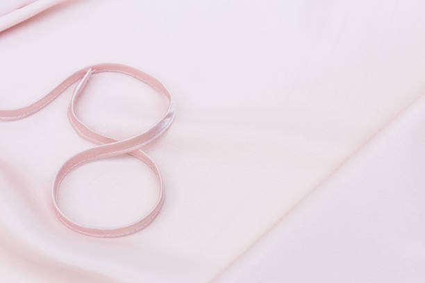 istock Abstract soft pink fabric texture background with number eight, silky pink fabric background 1308391306