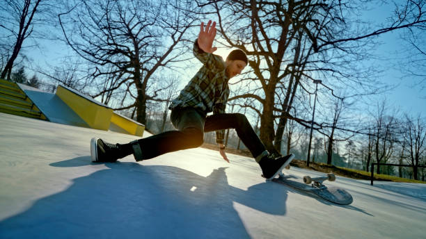 Young active man jumping ollie trick on skateboard and isolated on white background
