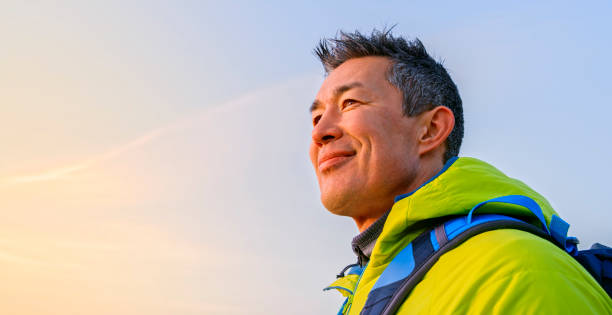 istock Close-up of mature man looking away while standing on mountain 1308391892