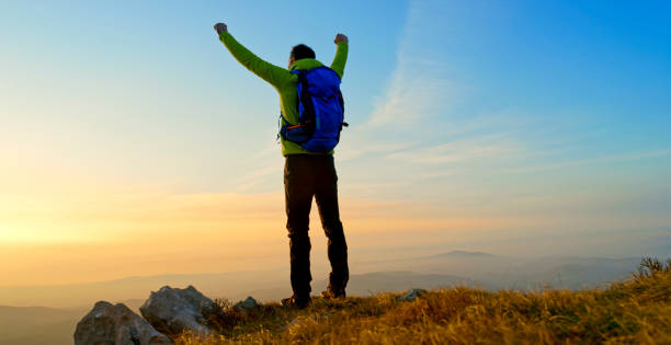 istock Mature man standing on mountain 1308391915
