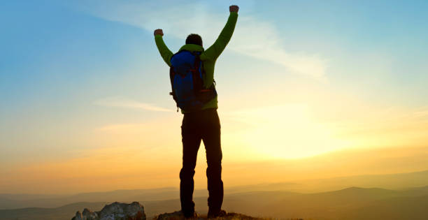 istock Mature man standing on mountain 1308392570