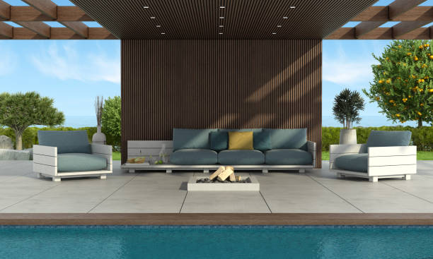 istock Modern sofa and armchairs by the pool under a wooden roof 1308393309