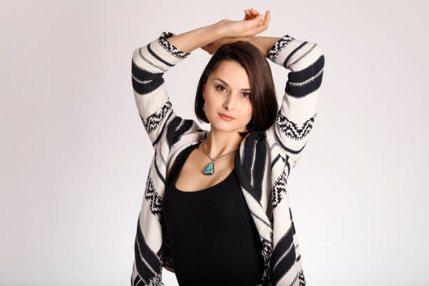 istock Aztec print clothes on beautiful young woman on white background 1308394151