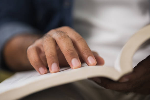 istock Close up male hand open book and reading. 1308394475
