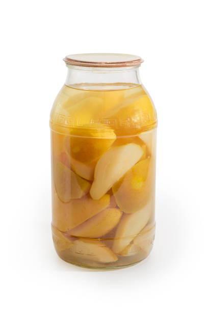 istock Canned pears in glass jar on a white background 1308394614
