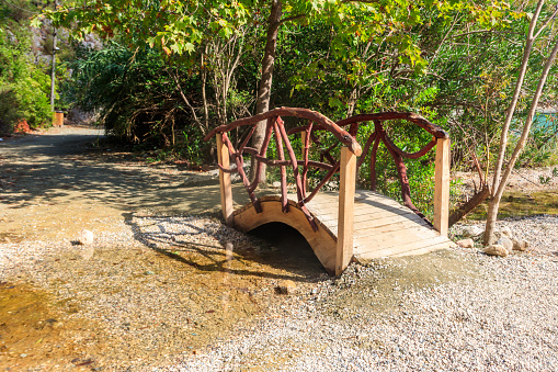 Small arched wooden footbridge in Goynuk canyon in Antalya province, Turkey