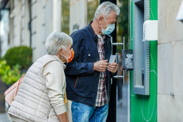 istock Senior Couple is Using ATM During a Pandemic Time. 1308395133