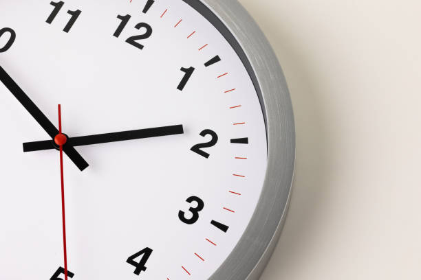 istock Large white clock, black numbers, red needle Set a timer on the white table 1308396260
