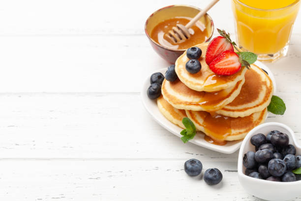 istock Healthy breakfast with pancakes and orange juice 1308396282