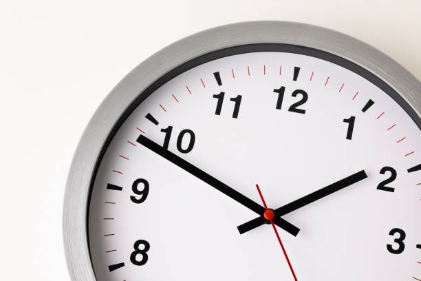 istock Large white clock, black numbers, red needle Set a timer on the white table 1308396285