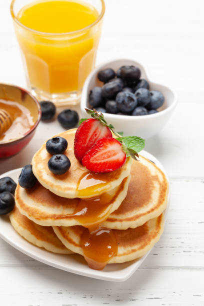 istock Healthy breakfast with pancakes and orange juice 1308396307