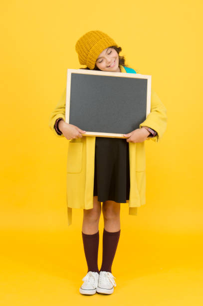 istock Ill do my own homework. Small child hold empty blackboard for homework on yellow background. School homework assignment. Tuition and homework, copy space 1308396331