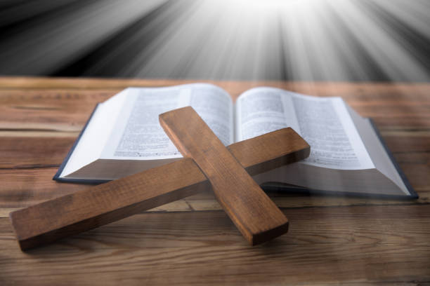 istock wooden cross with Holy Bible 1308396496