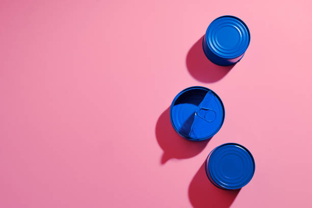 istock Aesthetic concept with blue painted tin can on pink background 1308397753