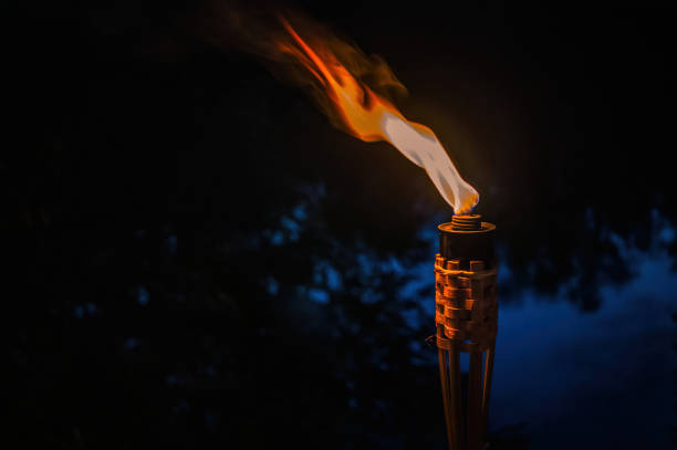 light and heat of a burning torch and a warm summer night. Light in the dark. Decorations for a summer country holiday