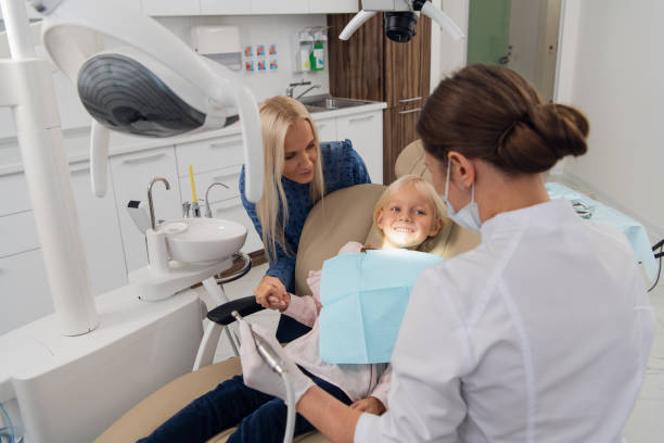Mom and her little daughter visiting a pediatric dental specialist stock photo