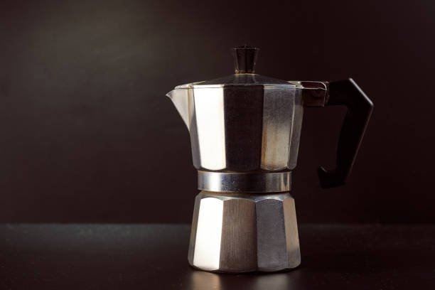 istock Geyser coffee maker on a dark background. Stylish silver coffee machine 1308399000