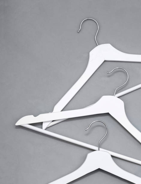 istock Creative top view flat lay white wooden hangers pastel grey background with copy space minimalism style. Template fashion social media sale store promo design feminine blog shopping concept 1308399787