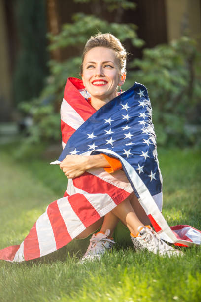 istock Woman with american flag 1308400761