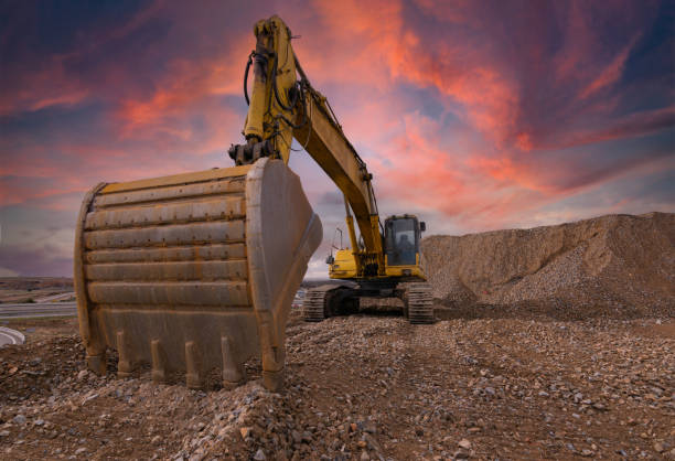 istock Excavator at the end of a working day in a construction site 1308402320