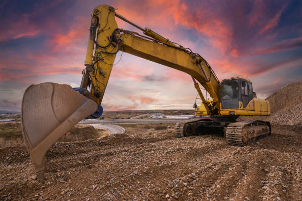 istock Excavator at the end of a working day in a construction site 1308402332