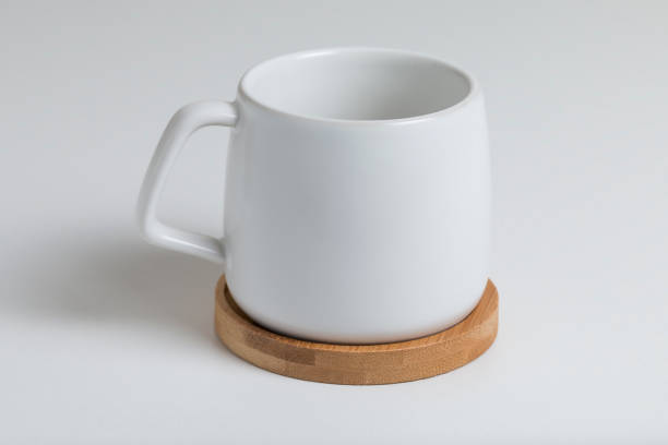 istock a white cup on a wooden stand on white background 1308403756