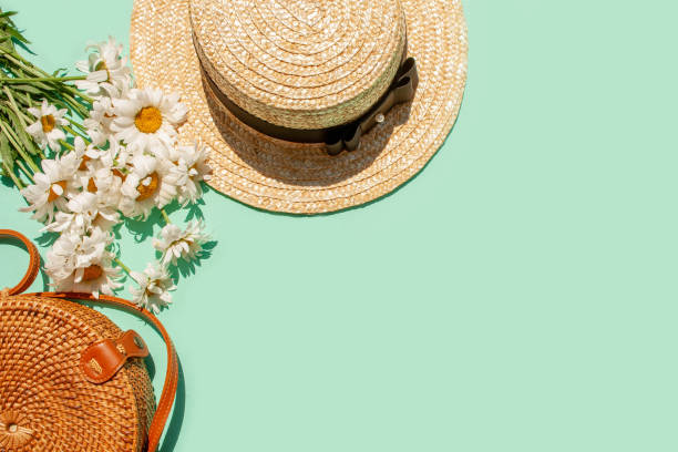 istock Wicker straw hat, wicker bag and daisies on a blue background 1308403781