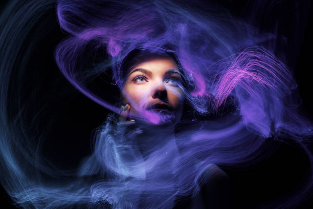 Multicolor abstract portrait of young woman on subject of creativity, imagination and art. lightpainting Fashion model woman in neon light, portrait of beautiful model with fluorescent make-up, Art design of female disco dancers posing in UV, colorful make up. Isolated on black background lightpainting stock pictures, royalty-free photos & images