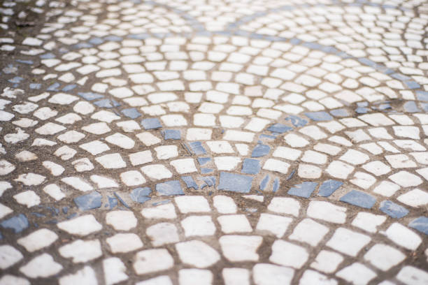 stone pavement texture, old square tiles on the road and sidewalk, old style stone paving stones, stone dirt road in the old town, paving slabs on the roads