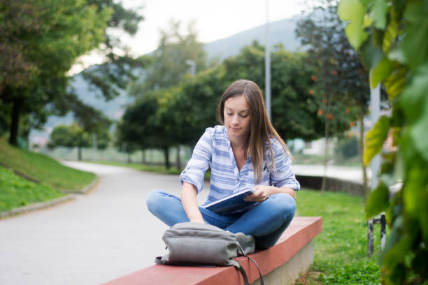 istock young woman sitting on bench 1308406608