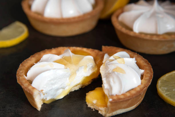istock lemon tartlet cut in half with honey on a dark background 1308407844