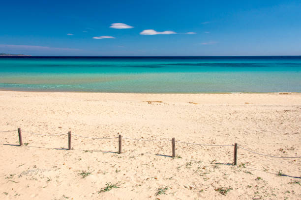 istock crystal clear water and white sand with blue sky for background 1308412002
