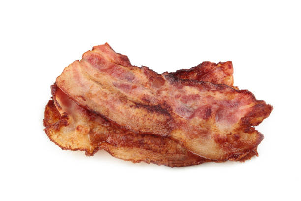 istock Crispy strips of bacon isolated on white background. 1308412033