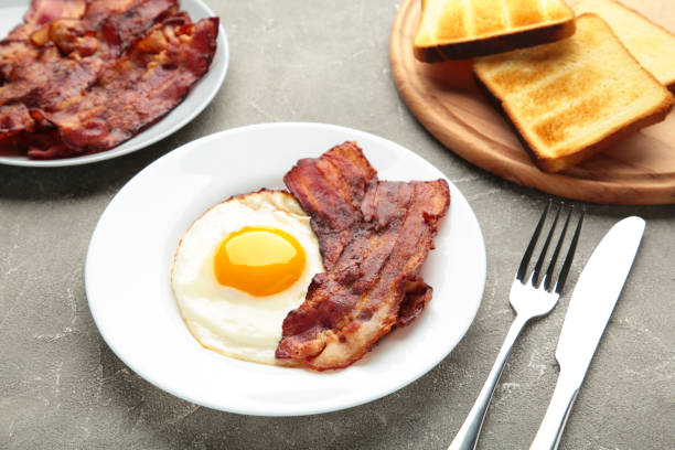 istock Eggs and bacon for breakfast on grey background. English breakfast. 1308412276