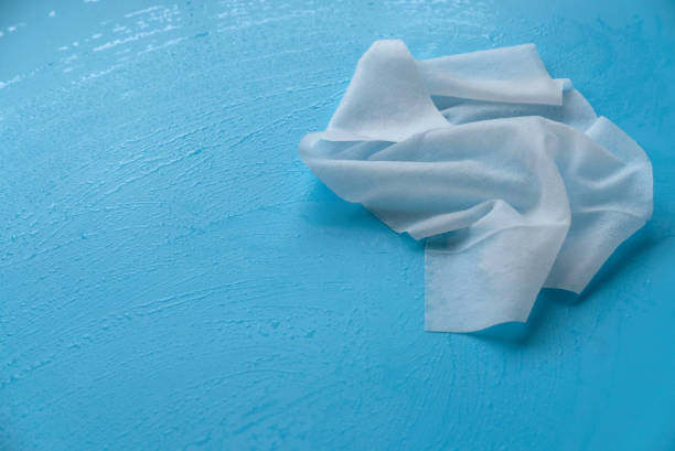 istock White tissue use to wipe blue background. 1308413790