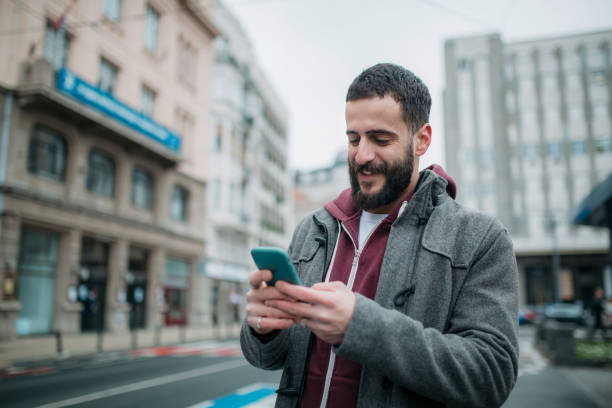 istock Happy Caucasian young man using a smart phone 1308414873
