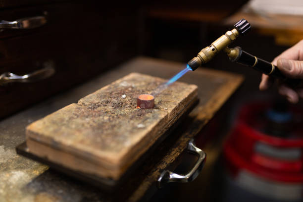istock goldsmith jeweler soldering a silver ring on the workbench with a soldering. 1308415033
