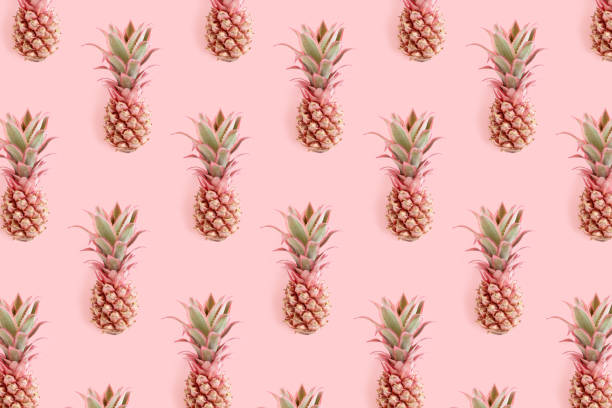 istock Trendy repetitive pattern made of pink pineapples. Summertime concept. 1308416452