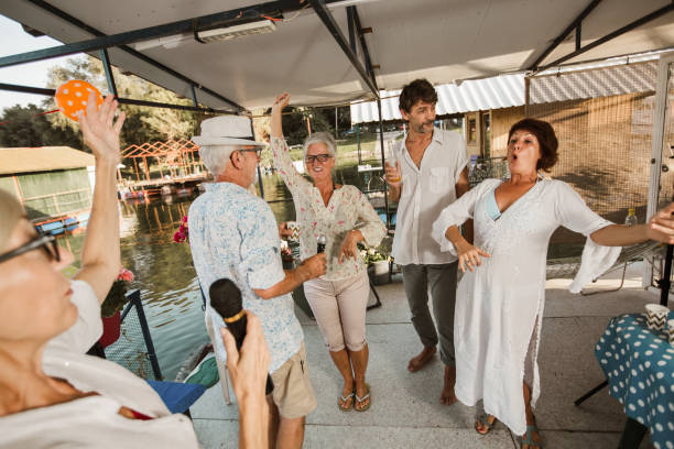 istock Senior people celebrating birthday singing karaoke. 1308416554