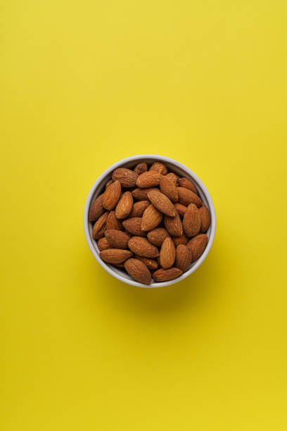 istock Almonds nuts shot on a color background 1308416792