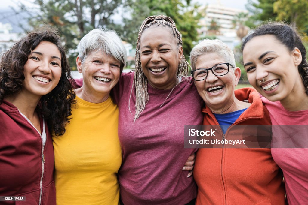 Happy multi generational women having fun together - Multiracial friends smiling on camera after sport workout outdoor - Main focus on african female face Women Stock Photo