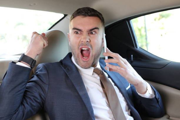 istock Angry businessman shouting in taxi 1308420097